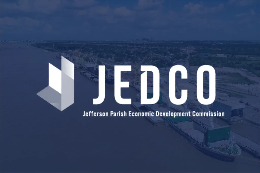 A cargo ship in the river, overlaid with a JEDCO logo