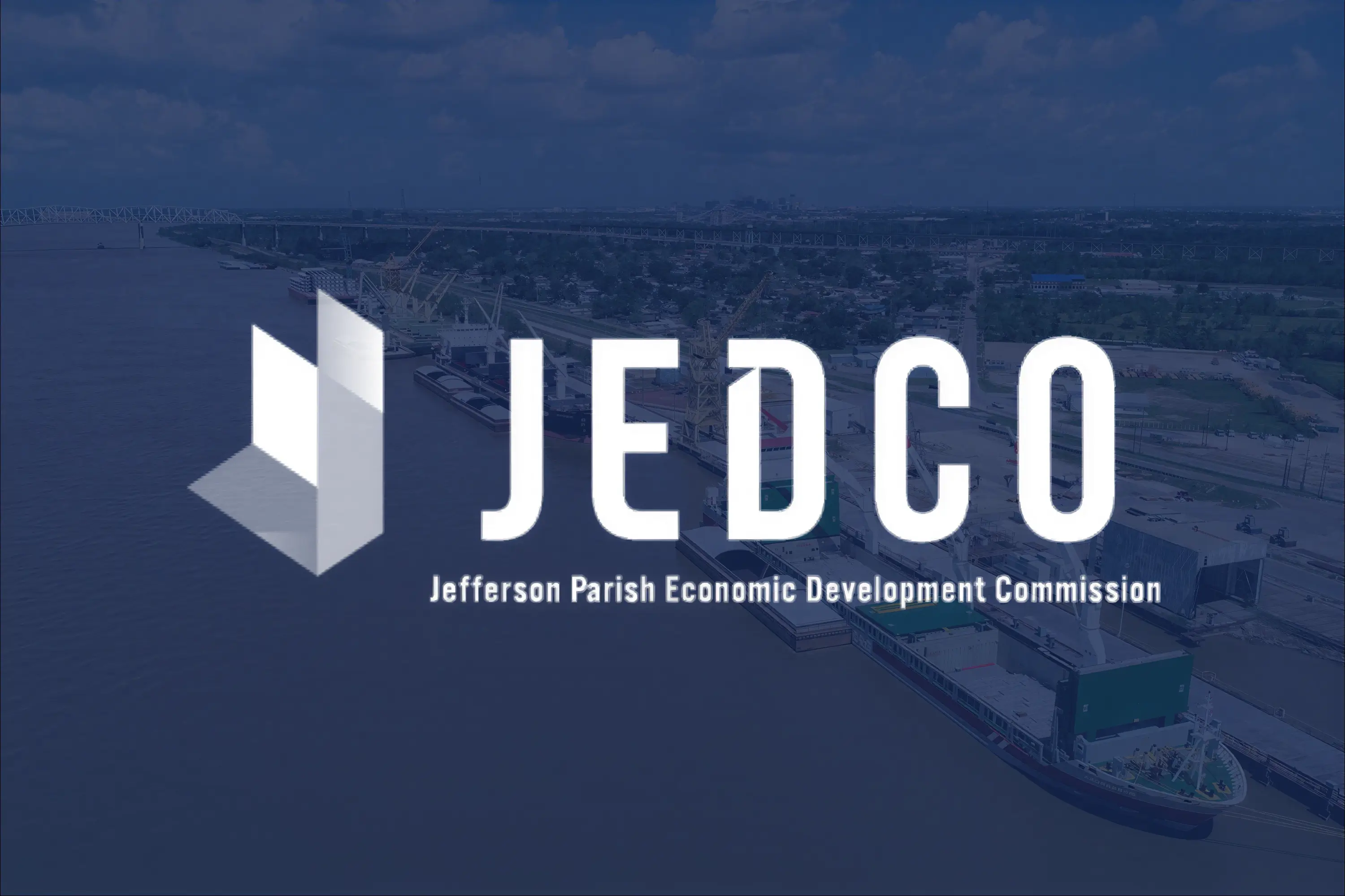 A cargo ship in the river, overlaid with a JEDCO logo