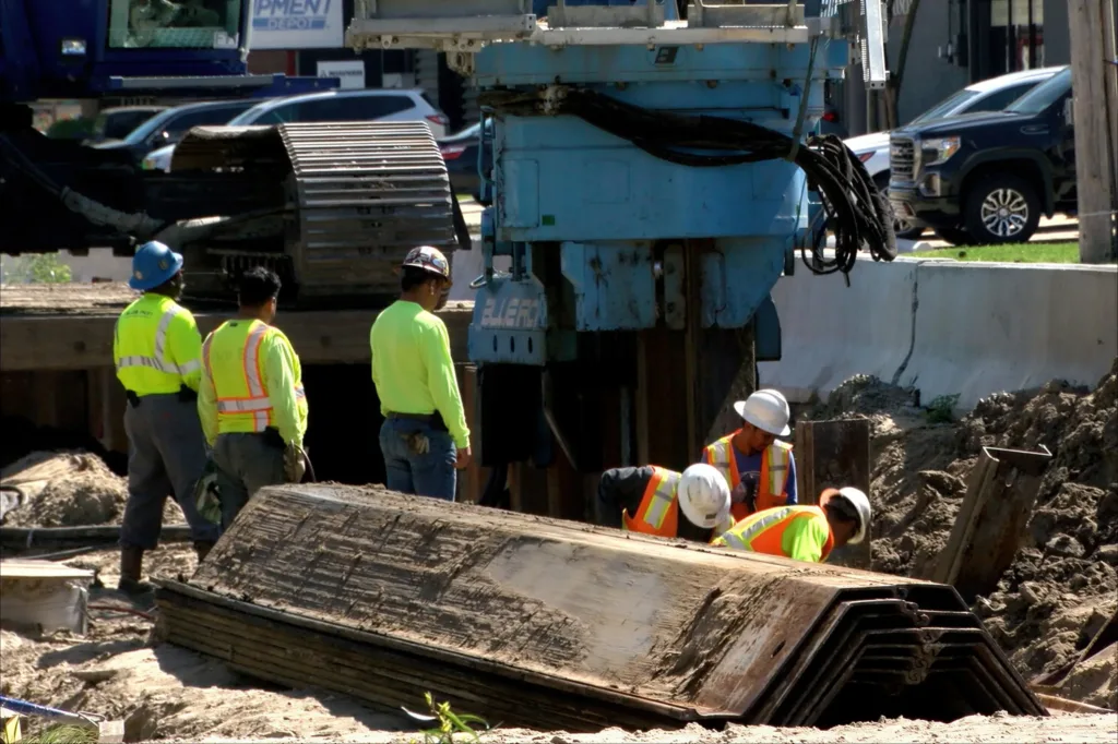 Construction workers installing drainage