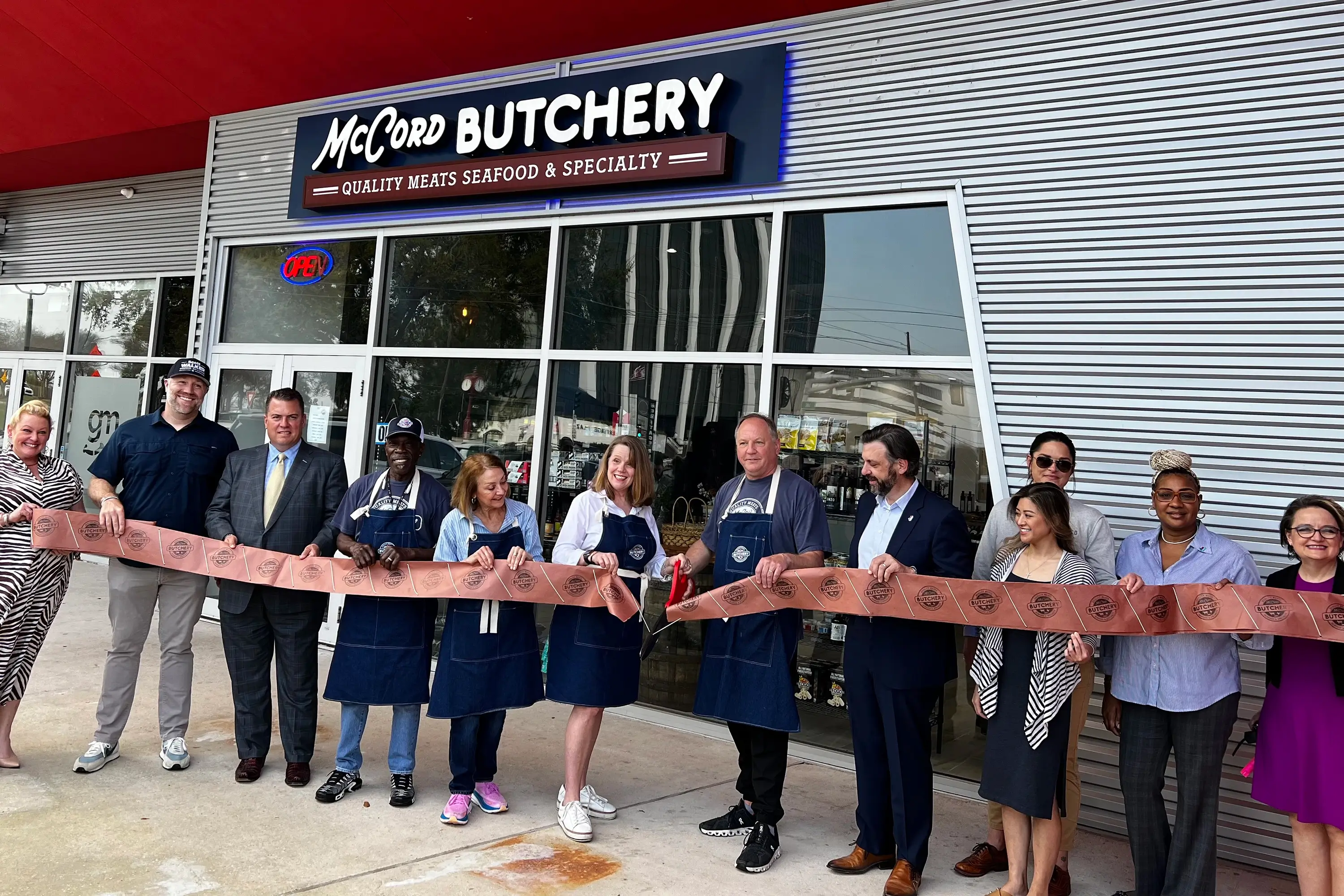 A ribbon cutting taking place outside McCord Butchery