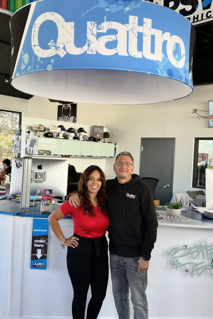 A man and woman in front of the Quattro sign