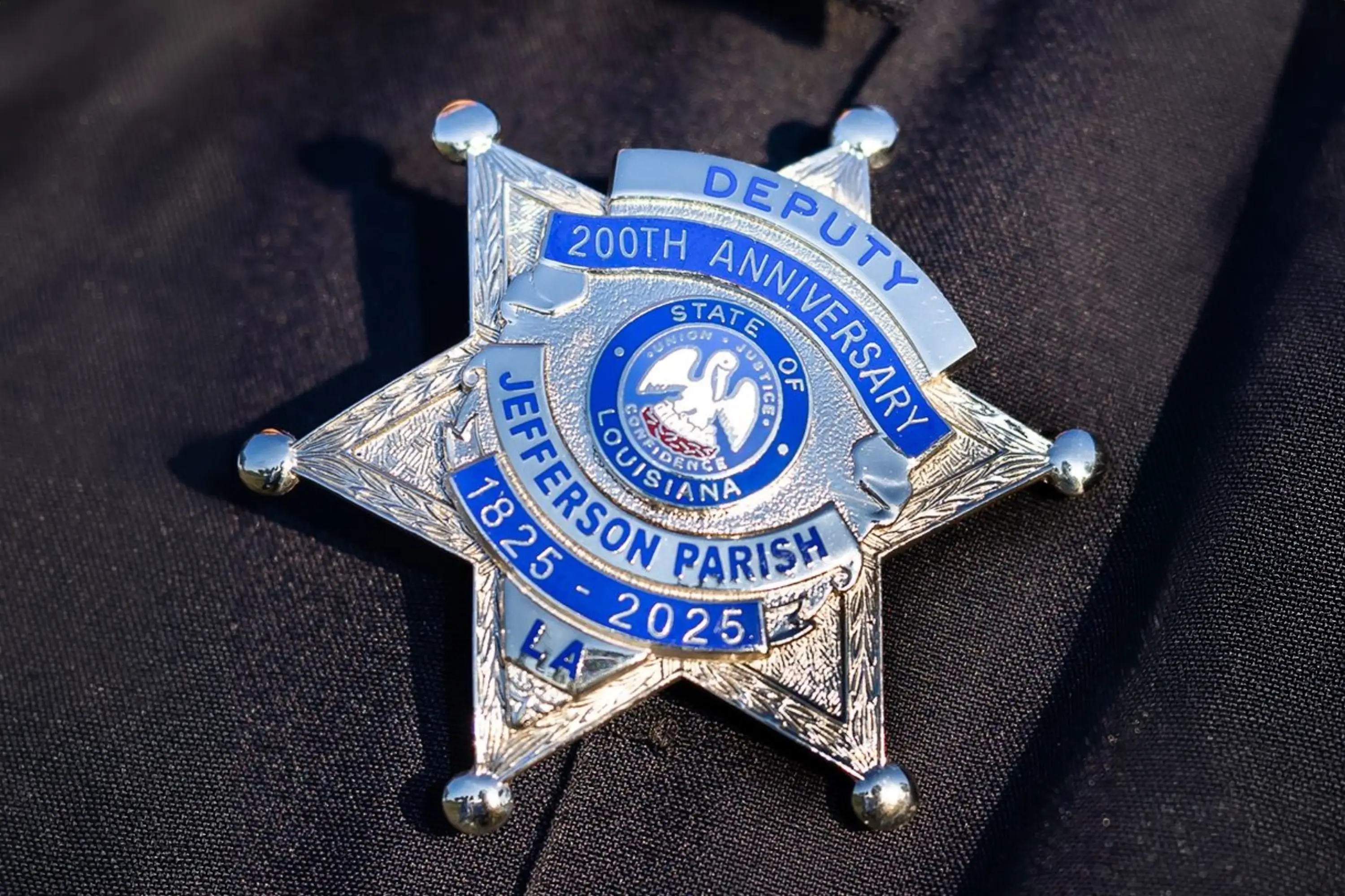 A Jefferson Parish Deputy badge laying on cloth